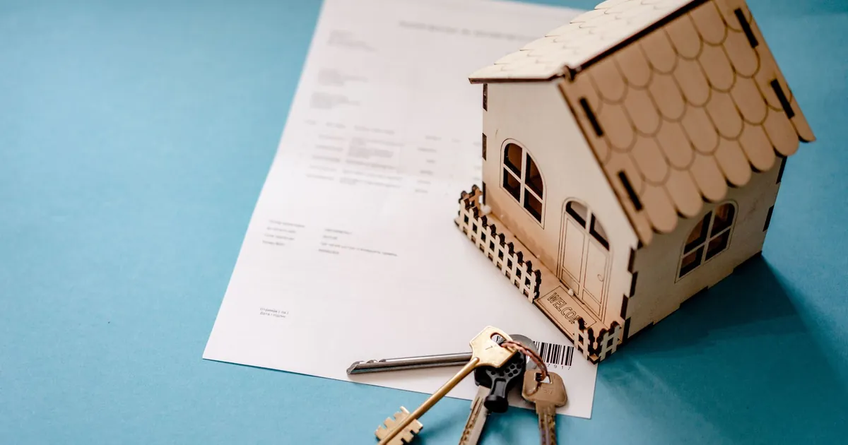 Mortgage loan paperwork and house keys on a desk