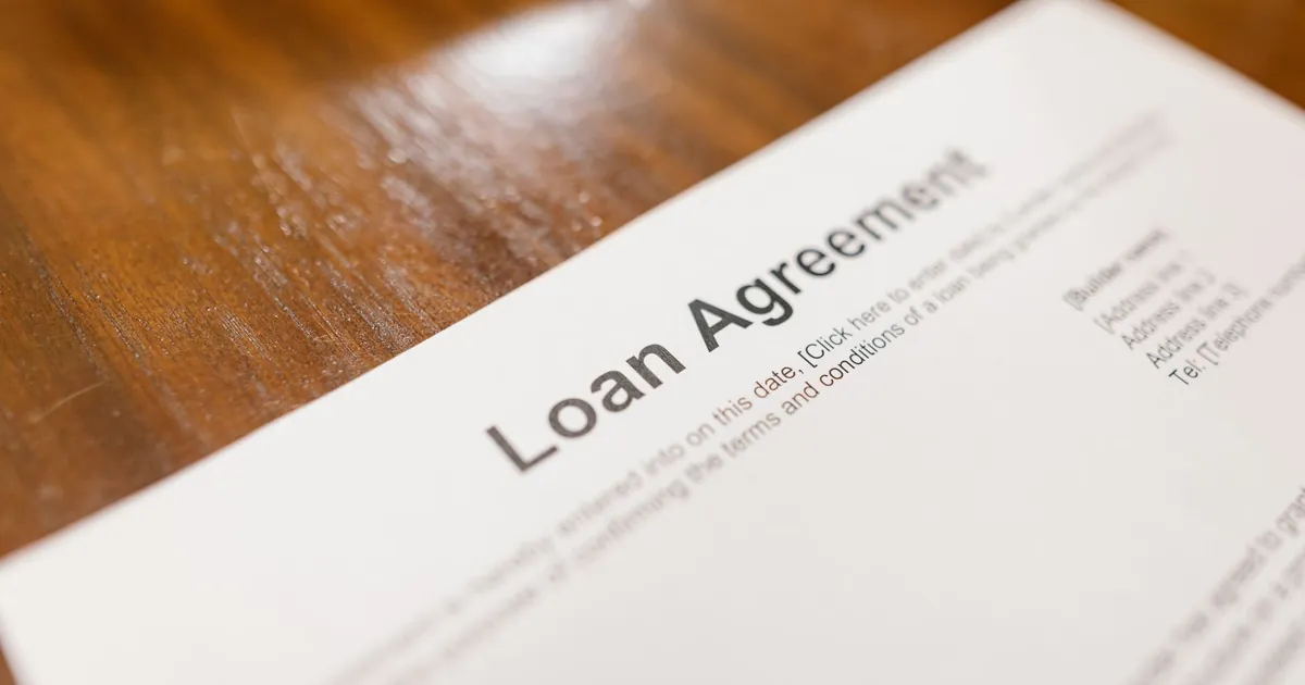 Mortgage loan paperwork and house keys on a desk