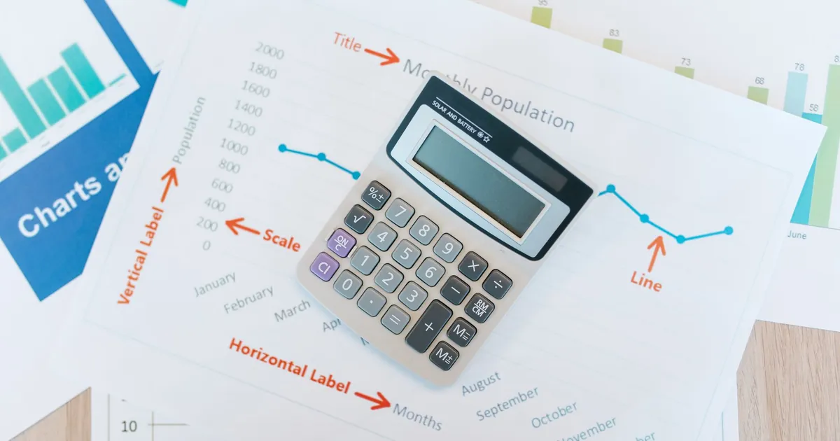 Financial documents and a calculator for reviewing debt and credit