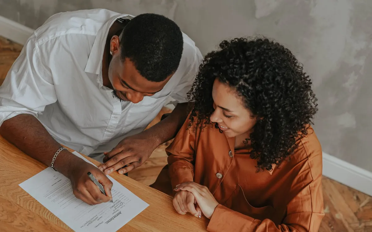 Buyers signing a purchase agreement